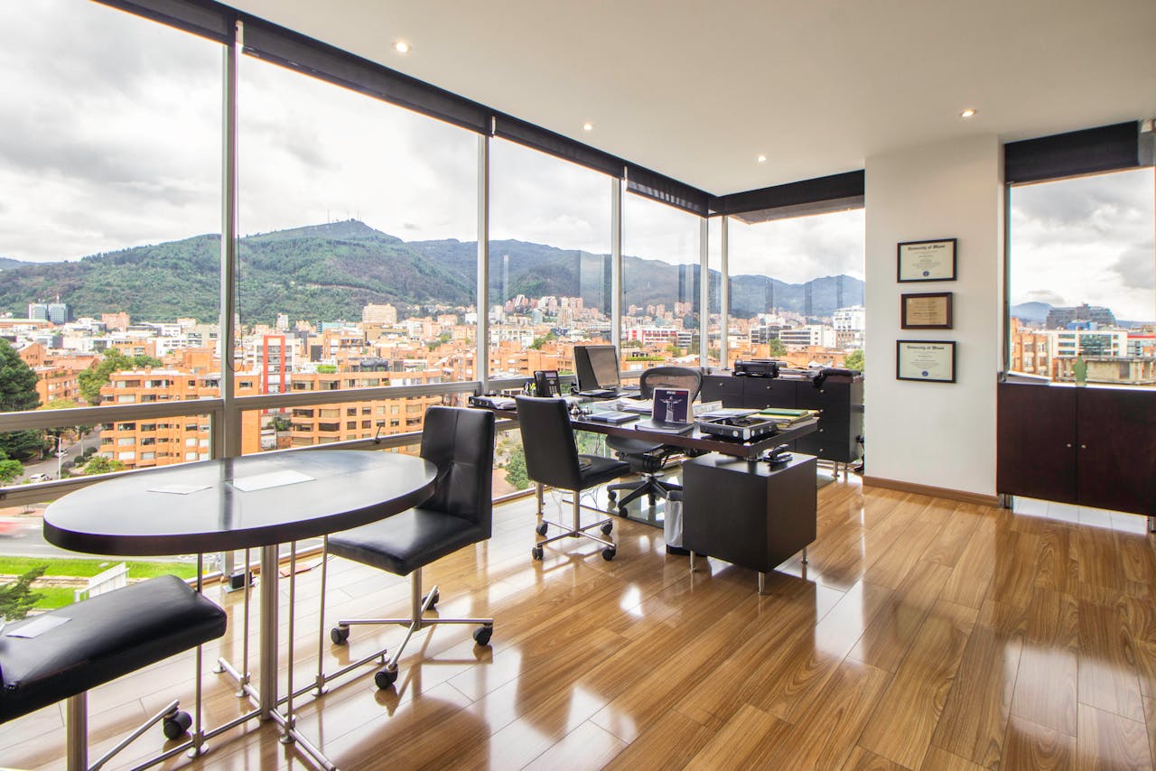 Spacious modern office with a scenic city view through glass windows.